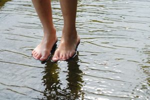 Feet standing in water