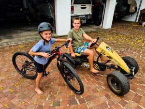Two barefoot boys, one on a bike